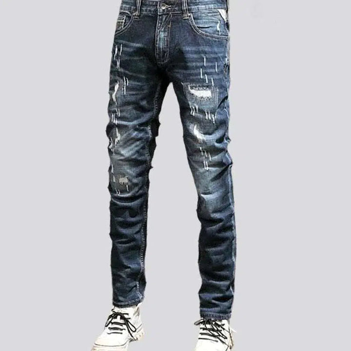 Grunge men's whiskered jeans