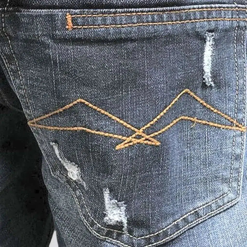 Grunge men's whiskered jeans